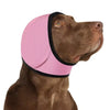 A brown dog wearing a pink and black calming noise reduction earmuff on its head.