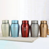 Five stainless steel pet memorial storage boxes in various colors lined up on a white surface