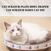 A fluffy white and gray cat is relaxing inside a bowl-shaped scratching basin for cats.