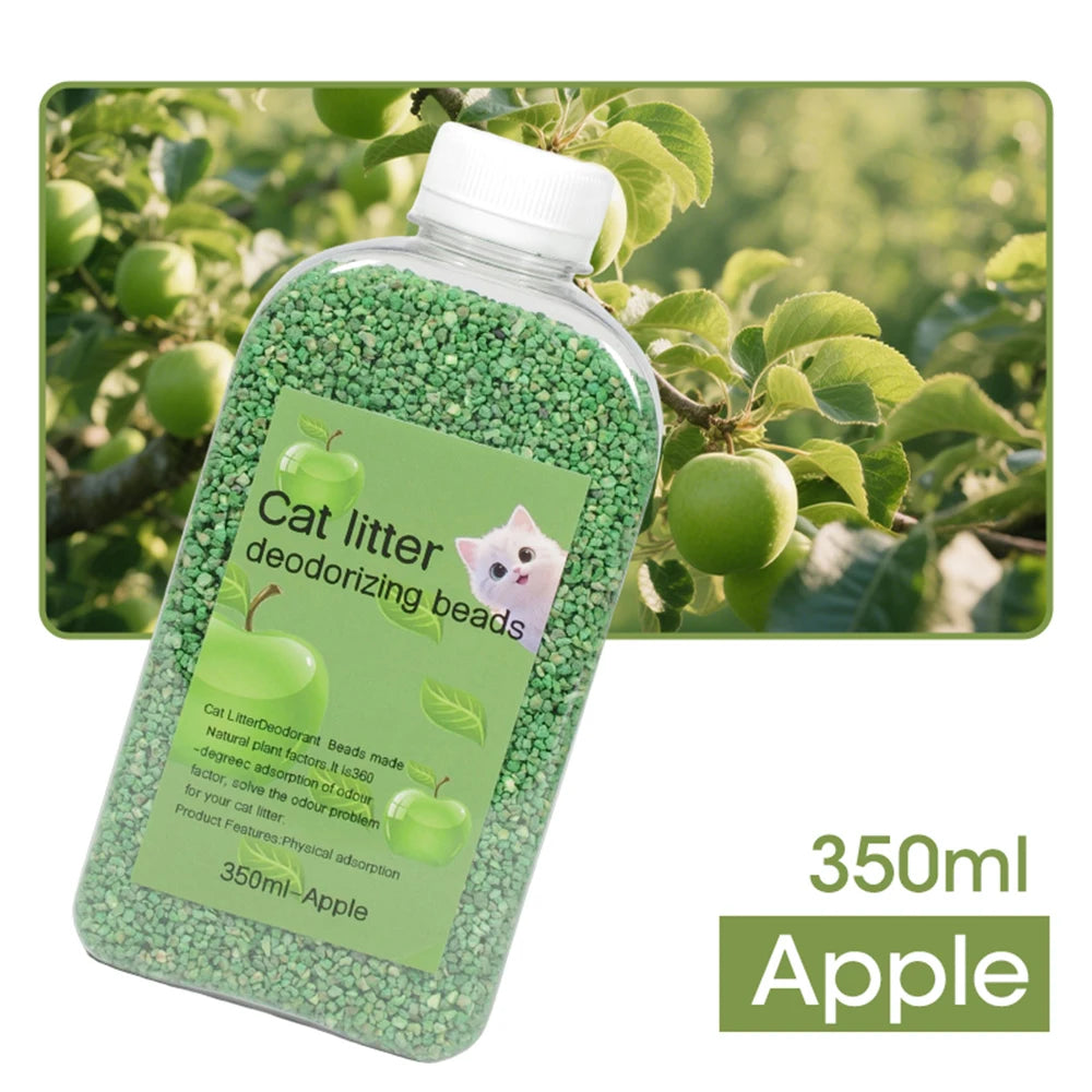 A clear bottle filled with green cat litter deodorizing beads, labeled Apple, set against a blurred outdoor background of gre