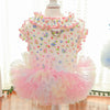 A pink floral princess pet dress for dogs and cats with ruffled collar and layered tulle skirt.