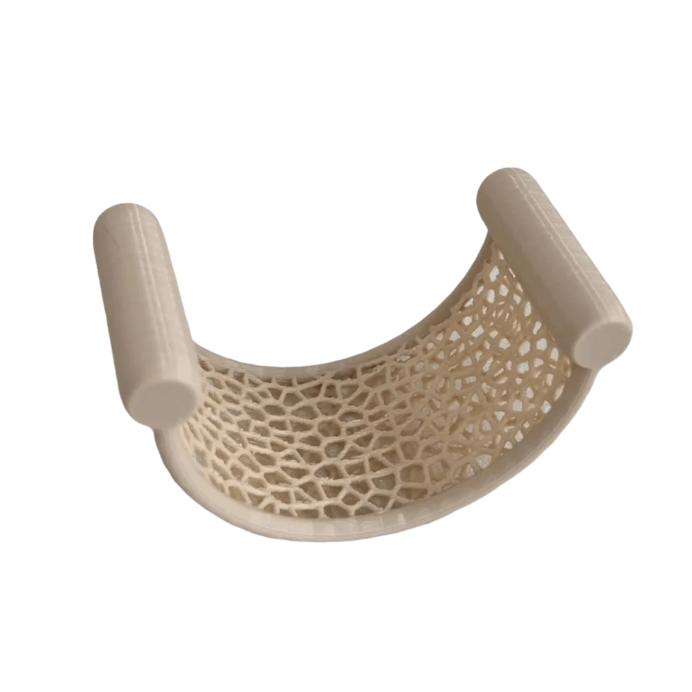 A 3D printed floating betta hammock for aquarium decor with a white, mesh-like structure and curved supports.