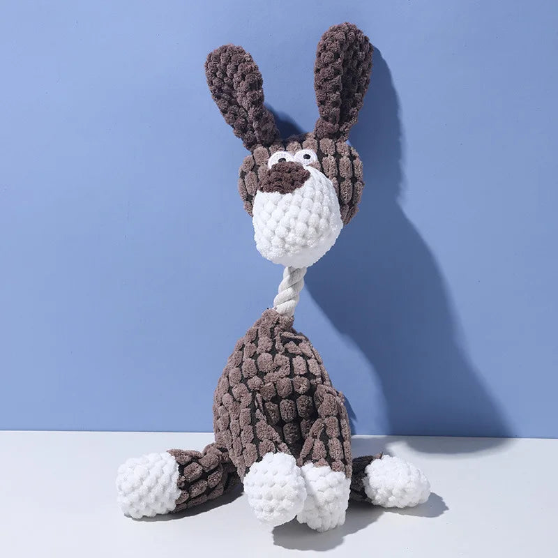A handmade plush toy of a donkey dog with dark brown fur and white accents, featuring a teeth cleaning texture.