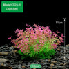 A dense cluster of red and green artificial aquarium plants growing in dark gravel.