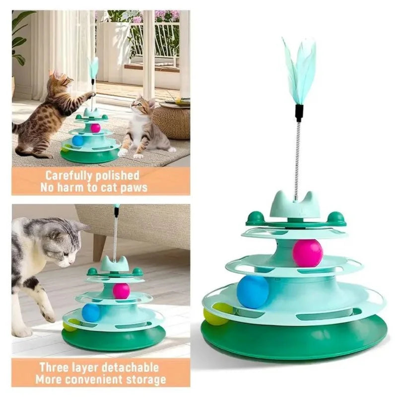 A multi-layered green and teal cat toy tower with a turntable and feather balls, shown in use with a tabby cat.