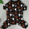 Black Halloween costume pajamas for dogs featuring orange pumpkin and spiderweb patterns