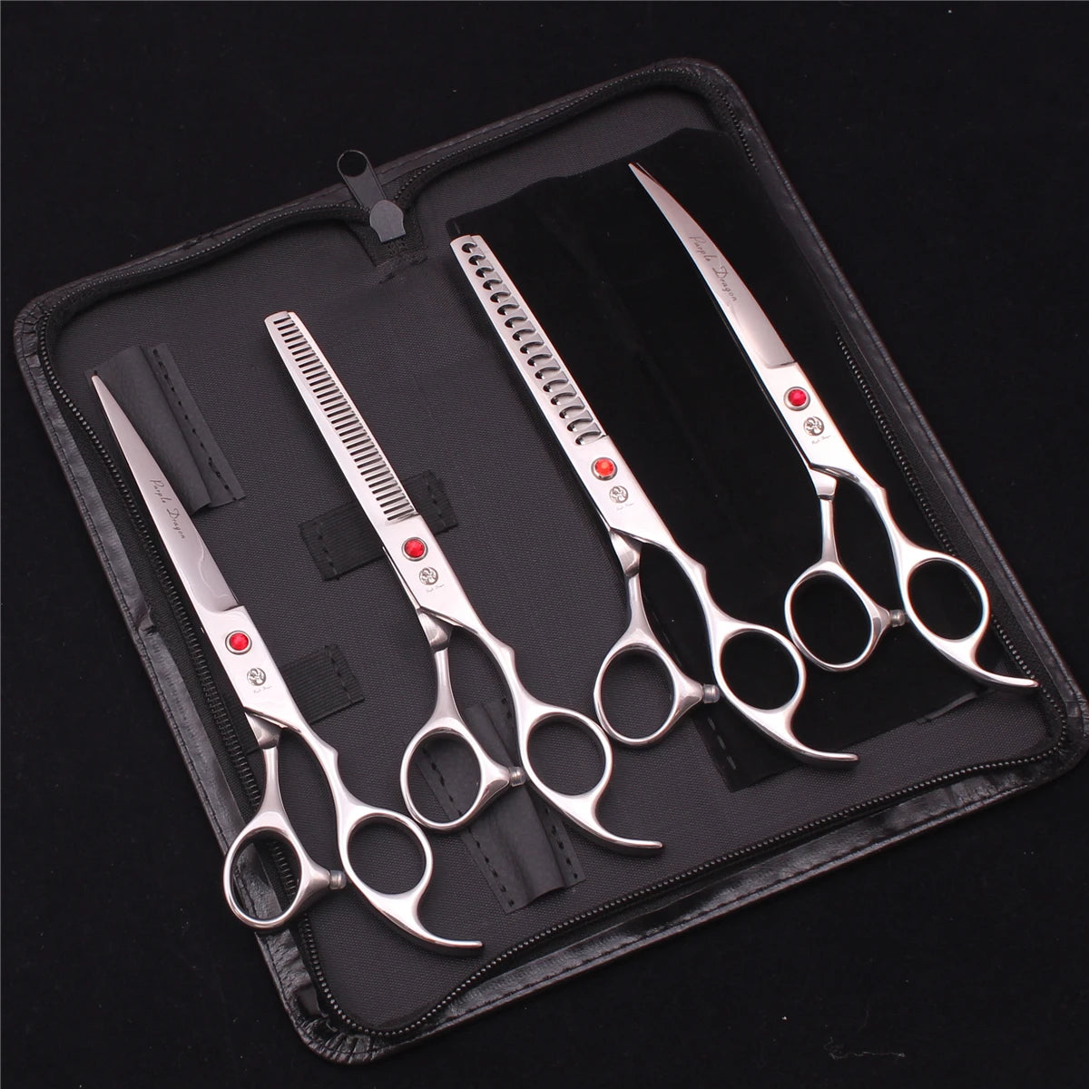 A black case holds a professional stainless steel pet grooming scissors set with various blades.