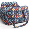 A durable pet car seat covered in a plaid fabric featuring blue, red, green, and yellow patterns.