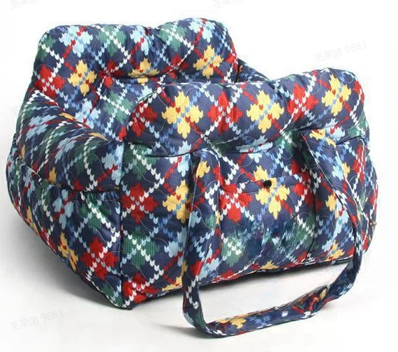 A durable pet car seat covered in a plaid fabric featuring blue, red, green, and yellow patterns.