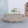 A beige corduroy pet sofa bed for dogs and cats resting on a light gray floor.