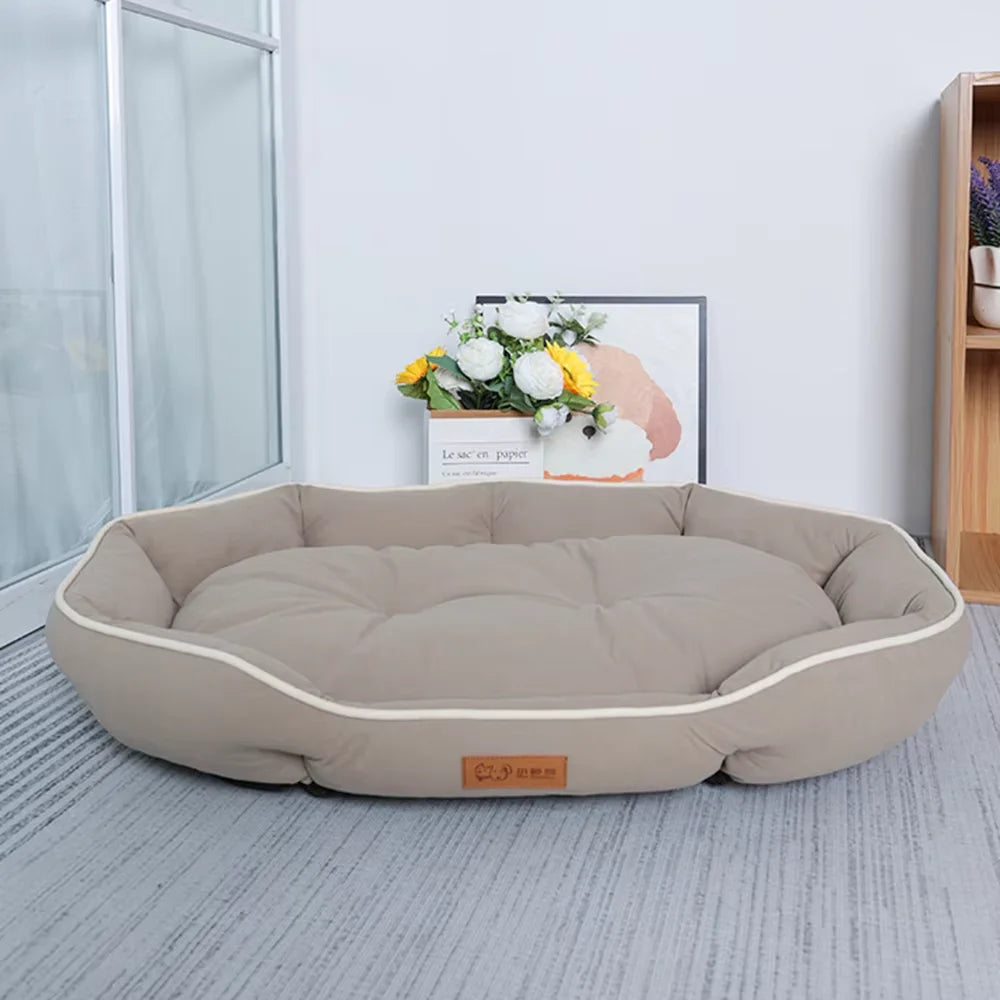 A beige corduroy pet sofa bed for dogs and cats resting on a light gray floor.