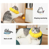 A tabby cat wearing a yellow plush Elizabethan collar, demonstrating playing and resting.