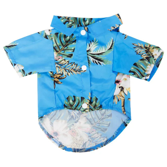 A light blue short-sleeved shirt with a tropical leaf print pattern for a dog.