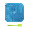 Blue silicone licking mat for pets with suction cups and a lime green silicone spoon