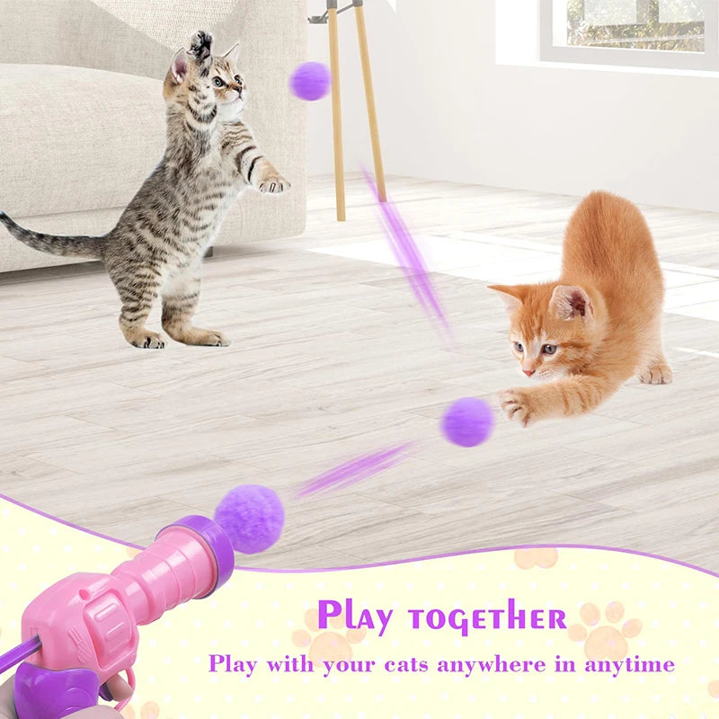 Pinkes interaktives Plüschkatze-Waffenspiel mit violetten Lichtstrahlen, das eine Kätzchen in einem Raum trifft.