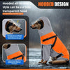 A dog wearing a hooded, all-in-one raincoat in gray and orange colors while standing in the rain.