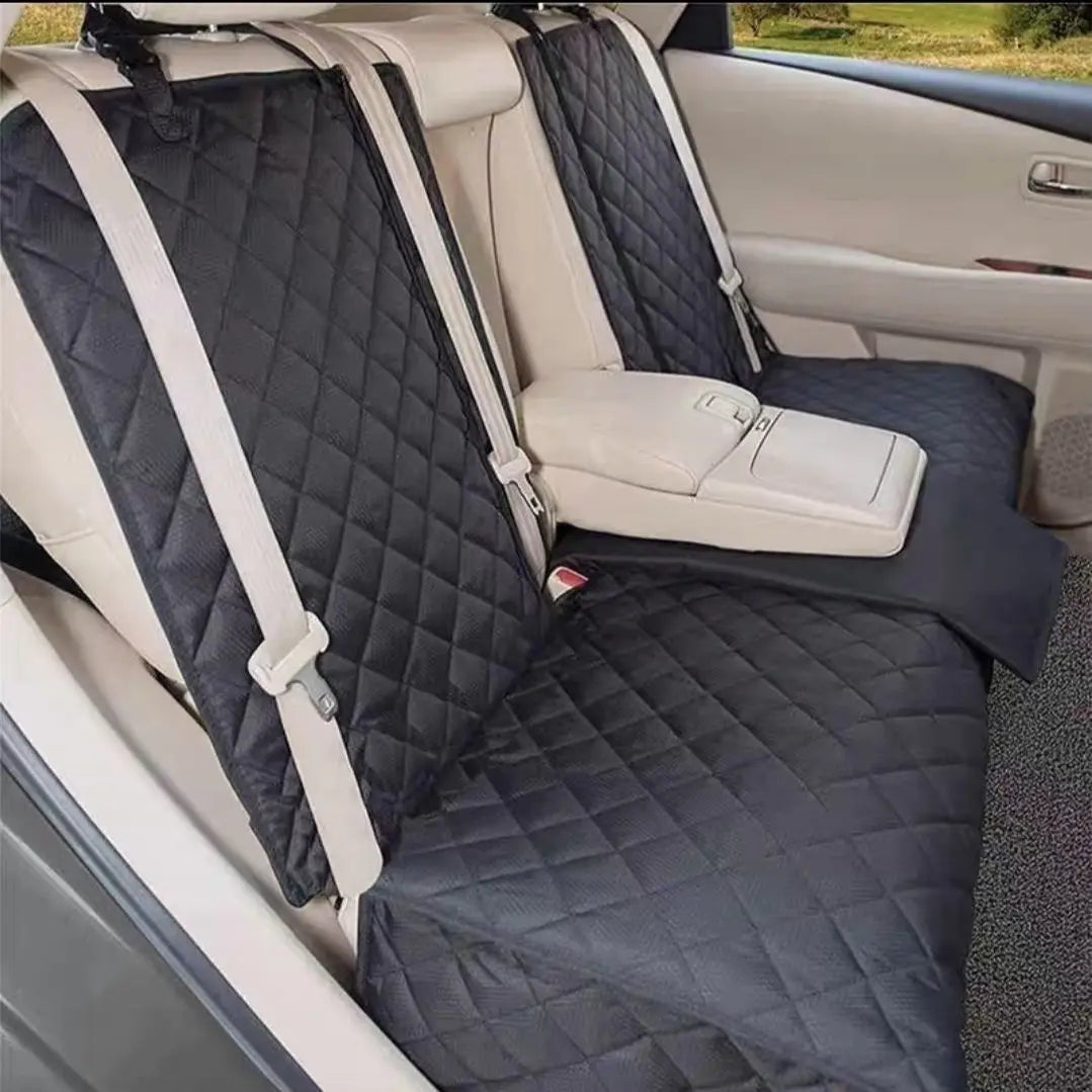 A black quilted waterproof dog car seat cover with a beige center armrest access in a vehicle interior.