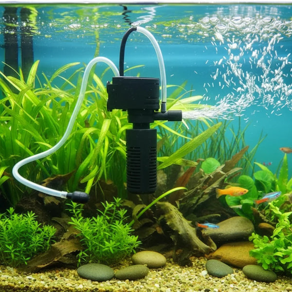 A black 3-in-1 aquarium filter pump is shown with tubing, circulating water and aeration over green aquatic plants.