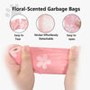 Pink floral-scented garbage bags being held by a hand, demonstrating easy tear and opening features.