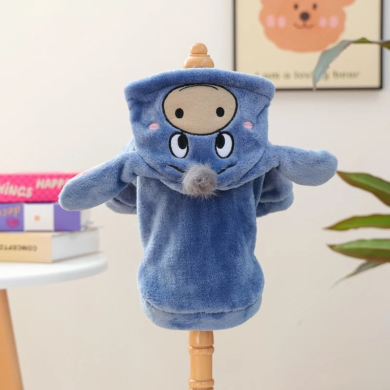 A blue flannel hoodie shaped like a dog is displayed on a wooden stand.