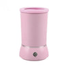 A pink automatic pet paw cleaner cup with a visible charging port.