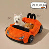 An orange supercar cat bed filled with a white dog and an orange cat, shown in a side view.