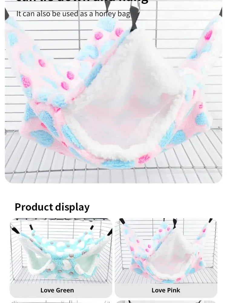 A pink and blue plush pet hammock displayed on a wire rack, shown in Love Green and Love Pink colors.