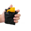A hand holds a black mesh storage bag with a yellow drawstring closure inside.