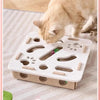 A cat is playing with an interactive puzzle toy designed for indoor playtime.