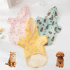 A yellow waterproof summer raincoat for dogs displayed next to a kitten and a small dog.