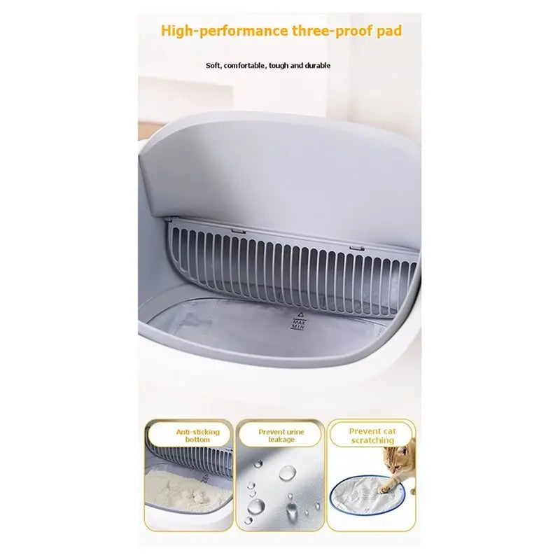 A close-up view of a white litter box with an open lid, showing the three-proof pad and related features.