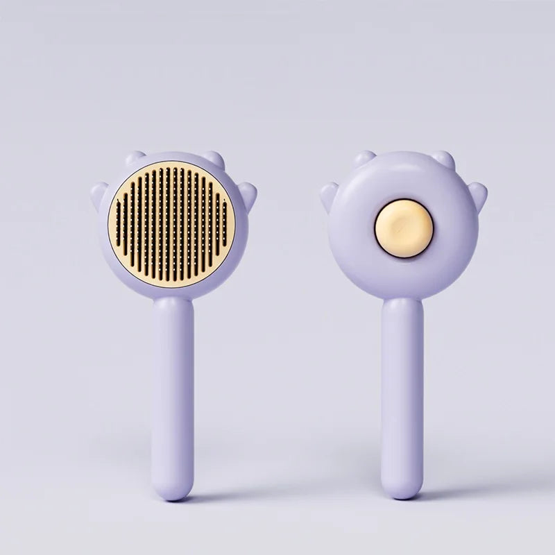 A pair of light purple pet hair removal slicker brushes with gold-colored bristles and round heads.