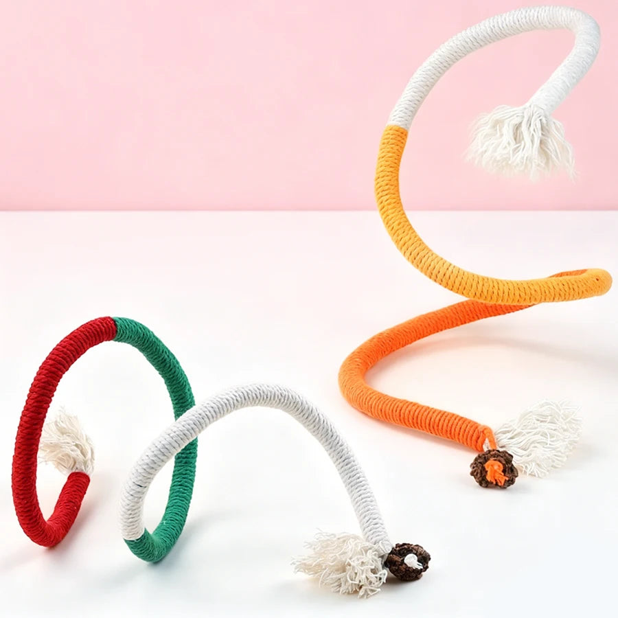 A set of interactive teeth grinding rope toys for cats in red, green, and orange with fluffy ends.