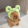 A cute green capybara plush doll wearing a fuzzy brown hoodie and small wings.