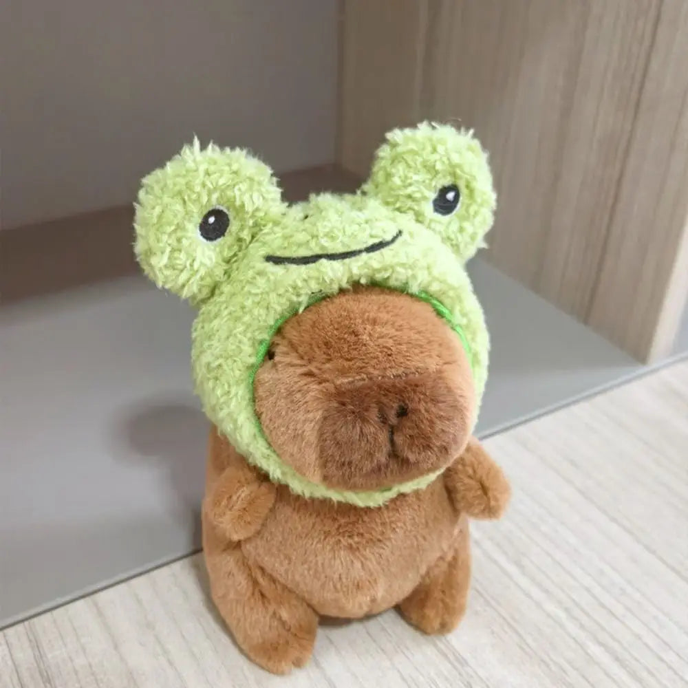 A cute green capybara plush doll wearing a fuzzy brown hoodie and small wings.