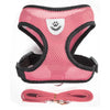 Pink pet harness and leash set for dogs and cats with a white paw print design