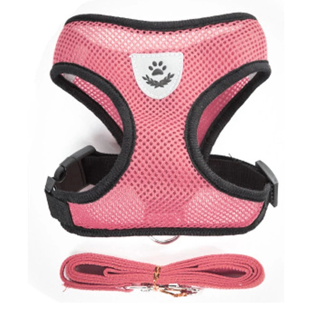 Pink pet harness and leash set for dogs and cats with a white paw print design
