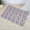 A rectangular washable pet training mat for dogs with a patterned design lying on a light wooden floor.