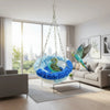 A vibrant blue bird is suspended in a hanging hammock made of fluffy blue feathers above a modern living room.
