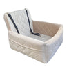 A beige quilted dog car seat with a removable orthopedic cushion and black straps.
