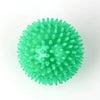 A bright green, spiky squeaky dog ball used for teeth cleaning and play.