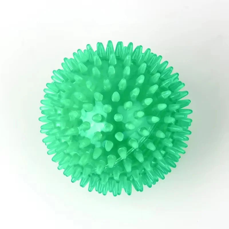 A bright green, spiky squeaky dog ball used for teeth cleaning and play.