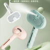 A light green pet spray massage comb and brush is shown with various components and a handle against a soft background.