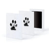 A set of three white framed prints featuring black paw prints for pet keepsake memories.