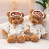 A fluffy teddy bear plush wearing a white pajama set and an eye mask, sitting on a light-colored sofa.