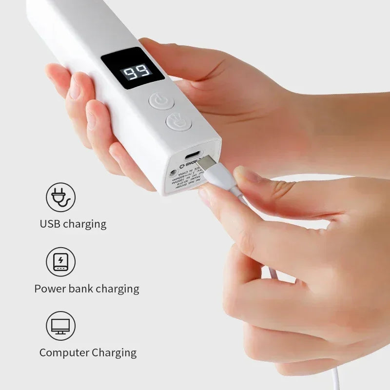 A hand holds a white pet nail grinder device displaying 9.9, demonstrating USB, power bank, and computer charging options.