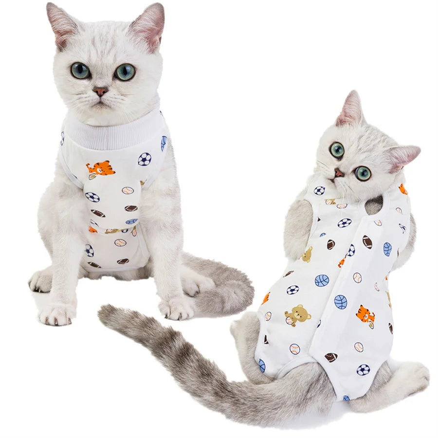 A fluffy gray cat wearing a white recovery vest with various small toys on it.