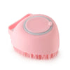A pink silicone pet bathing massage glove with a handle and a bristled pad.