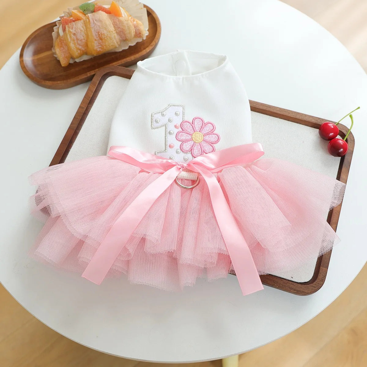 Elegant birthday suit for dogs featuring a white tulle top with a pink floral detail