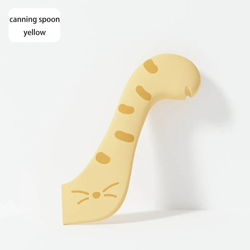 A yellow silicone canning spoon with a sealing lid shown in profile.